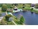 Aerial view of a lake with a wooden dock and surrounding lush greenery at 3692 Glen Oaks Manor Dr, Sarasota, FL 34232