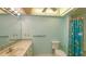 Bathroom with vanity, sink, toilet and shower with tropical themed shower curtain at 3692 Glen Oaks Manor Dr, Sarasota, FL 34232