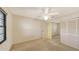 Bedroom with carpeted floor, ceiling fan, closet and window providing natural light at 3692 Glen Oaks Manor Dr, Sarasota, FL 34232