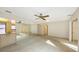 Bedroom featuring carpeted floors, a ceiling fan, mirrored wall and a hallway leading to the bathroom at 3692 Glen Oaks Manor Dr, Sarasota, FL 34232