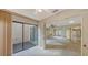 Carpeted bedroom with a sliding glass door opening onto a lanai, enhancing the interior lighting at 3692 Glen Oaks Manor Dr, Sarasota, FL 34232
