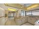 Bright kitchen features white appliances, tiled floor, and a sunny view of the outdoor pool at 3692 Glen Oaks Manor Dr, Sarasota, FL 34232