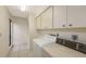 Laundry room with washer, dryer, cabinets and a window at 3692 Glen Oaks Manor Dr, Sarasota, FL 34232