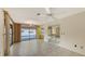 Spacious living room featuring tile flooring and sliding glass doors opening to the outdoor pool area at 3692 Glen Oaks Manor Dr, Sarasota, FL 34232