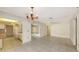 Bright living room features tile floors with easy access to kitchen and views of backyard at 3692 Glen Oaks Manor Dr, Sarasota, FL 34232
