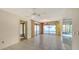 Open living room features sliding doors to pool, and neutral tile for a bright interior space at 3692 Glen Oaks Manor Dr, Sarasota, FL 34232