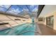 Enclosed pool area with serene blue water and sun-drenched patio, offering a tranquil escape at 3692 Glen Oaks Manor Dr, Sarasota, FL 34232