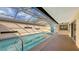 Inviting enclosed pool with clear water, surrounded by a bright patio and a view of the home's exterior at 3692 Glen Oaks Manor Dr, Sarasota, FL 34232