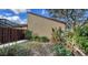Side yard of a home showing lush landscaping and a privacy fence at 3692 Glen Oaks Manor Dr, Sarasota, FL 34232