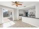 Bright kitchen features white cabinets, granite countertops, and sliding glass doors to the backyard at 3715 Bond Pl, Sarasota, FL 34232