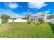 Large backyard with lush green lawn, patio area, and partial privacy fence at 3831 Day Bridge Pl, Ellenton, FL 34222