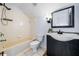 Bathroom with tub, shower and dark vanity cabinet at 3831 Day Bridge Pl, Ellenton, FL 34222