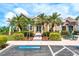 Exterior shot of the community clubhouse with palm trees and ample parking spaces at 3831 Day Bridge Pl, Ellenton, FL 34222