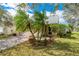Charming home featuring a well-maintained lawn, palm trees, and an attached two-car garage at 3831 Day Bridge Pl, Ellenton, FL 34222