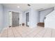 Inviting foyer with neutral ceramic tile, front door with sidelights, and staircase to the second floor at 3831 Day Bridge Pl, Ellenton, FL 34222