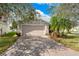 Charming one-story home featuring a well-kept lawn, beige siding, and a convenient two-car garage at 3831 Day Bridge Pl, Ellenton, FL 34222