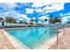 Community swimming pool with ample lounge chairs, clear blue water, and sunny skies at 3831 Day Bridge Pl, Ellenton, FL 34222