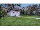 Spacious backyard featuring a storage shed with a concrete pathway and lush lawn at 4045 Lisbon Pl, Sarasota, FL 34231