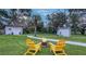 Backyard features a fire pit with Adirondack chairs, landscaping and outbuildings at 4045 Lisbon Pl, Sarasota, FL 34231
