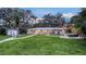 Expansive backyard features a lush lawn, patio area with furniture, and outdoor grill at 4045 Lisbon Pl, Sarasota, FL 34231