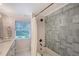 Beautiful bathroom featuring a shower-tub with subway and blue accent tile at 4045 Lisbon Pl, Sarasota, FL 34231