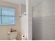 Clean bathroom features a modern toilet and a stylish tiled shower, providing an attractive space at 4045 Lisbon Pl, Sarasota, FL 34231