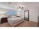 Relaxing bedroom features a comfortable bed, side tables with lamps, a ceiling fan, and a stylish full-length mirror at 4045 Lisbon Pl, Sarasota, FL 34231