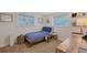 Cozy bedroom features a bed, side table, decorated desk, and ample natural light through multiple windows at 4045 Lisbon Pl, Sarasota, FL 34231