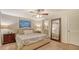 Relaxing bedroom features a comfortable bed, side tables with lamps, a ceiling fan, and a stylish full-length mirror at 4045 Lisbon Pl, Sarasota, FL 34231