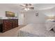 Comfortable bedroom with a dresser, a ceiling fan, carpeted floor, and artwork on the wall for a relaxing space at 4045 Lisbon Pl, Sarasota, FL 34231