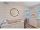 Charming Bedroom featuring shiplap walls, a round mirror, and a changing table with drawers for ample storage at 4045 Lisbon Pl, Sarasota, FL 34231