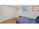Bedroom features white walls, a window with blinds, and a wardrobe at 4045 Lisbon Pl, Sarasota, FL 34231