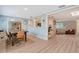 The dining room has pale green walls, a wood table and chairs, and an opening to the kitchen and playroom at 4045 Lisbon Pl, Sarasota, FL 34231