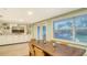 Inviting dining room with a large window, complemented by built-in shelving and decorative display, bright and airy space at 4045 Lisbon Pl, Sarasota, FL 34231
