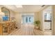 Dining room boasts light wood flooring, stylish furnishings, and an abundance of natural light at 4045 Lisbon Pl, Sarasota, FL 34231