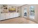 Bright dining area showcasing a built-in display, seamlessly flowing to the outdoor patio with a grilling area at 4045 Lisbon Pl, Sarasota, FL 34231