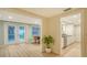 Light-filled dining area with wood floors, and an adjacent modern kitchen with stainless steel appliances at 4045 Lisbon Pl, Sarasota, FL 34231