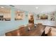 Light-filled dining room features a large wooden table and built-in shelving with decorative display, creating an inviting atmosphere at 4045 Lisbon Pl, Sarasota, FL 34231