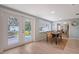 A dining room features a table with chairs and French doors that leads out to the backyard patio at 4045 Lisbon Pl, Sarasota, FL 34231