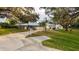 Beautiful home with a metal roof, mature trees, and a well-kept lawn at 4045 Lisbon Pl, Sarasota, FL 34231