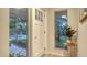 The home's entry foyer features a white door, hardwood floors and an exterior view at 4045 Lisbon Pl, Sarasota, FL 34231