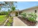 Charming single-story home featuring landscaped walkway to the front door at 4045 Lisbon Pl, Sarasota, FL 34231