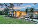 Inviting front exterior with landscaped walkway, well-maintained lawn, and charming curb appeal at 4045 Lisbon Pl, Sarasota, FL 34231