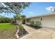 Close up of the front exterior of a single-story home featuring an entrance walkway and tropical landscaping at 4045 Lisbon Pl, Sarasota, FL 34231