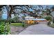 Well-maintained single-story home with mature landscaping and a metal roof at 4045 Lisbon Pl, Sarasota, FL 34231