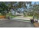 Charming single-story home featuring a gated driveway and mature trees at 4045 Lisbon Pl, Sarasota, FL 34231