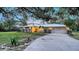 Well-maintained single-story home with manicured lawn, lovely landscaping, and a metal roof at 4045 Lisbon Pl, Sarasota, FL 34231
