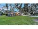 Charming single-story home with a well-manicured lawn and mature landscaping at 4045 Lisbon Pl, Sarasota, FL 34231