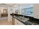 A kitchen features dark countertops, stainless steel appliances, and a sink with views to an adjacent dining area at 4045 Lisbon Pl, Sarasota, FL 34231