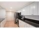 Modern kitchen features sleek countertops, white cabinets, stainless steel appliances, and wood floors at 4045 Lisbon Pl, Sarasota, FL 34231